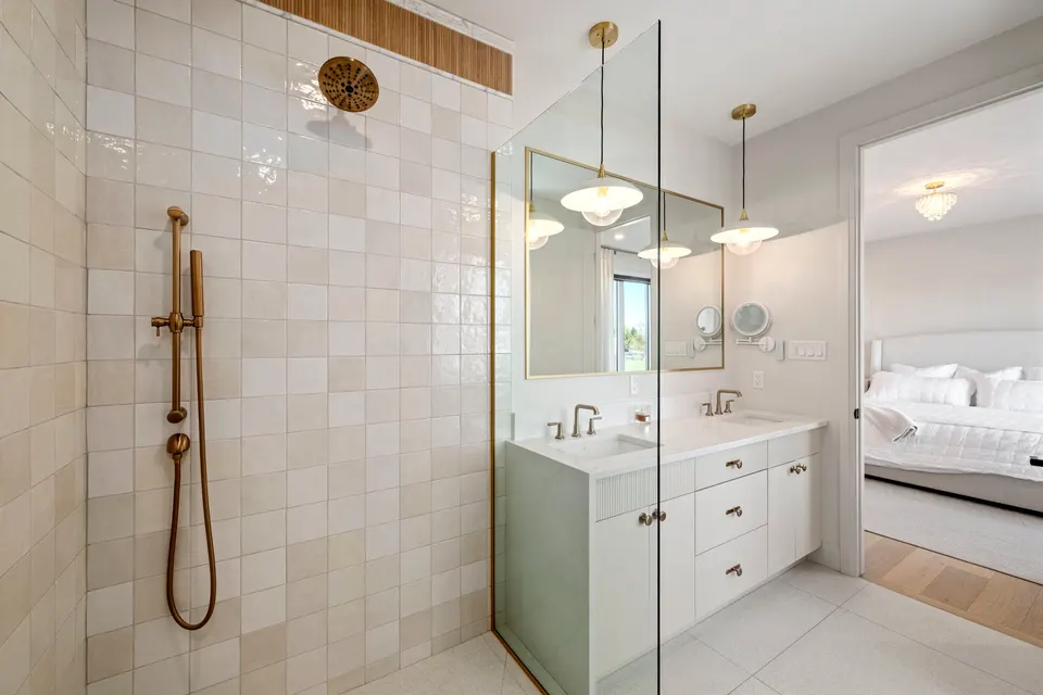 Glass walk-in shower with brass fixtures