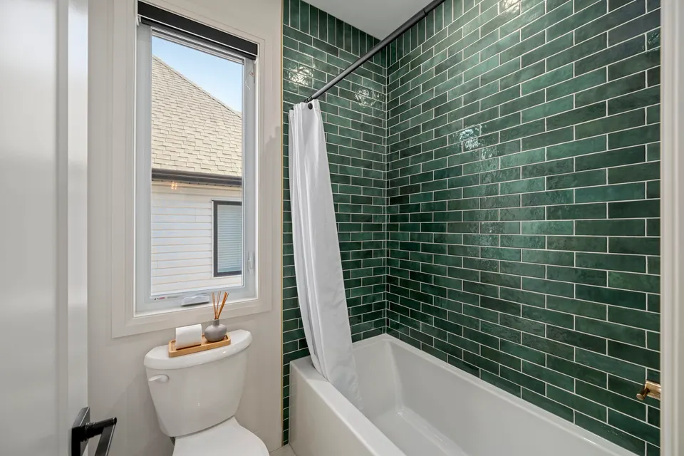 Shared bath with green tile