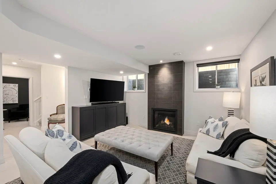 Lower level recreation room with fireplace and sectional