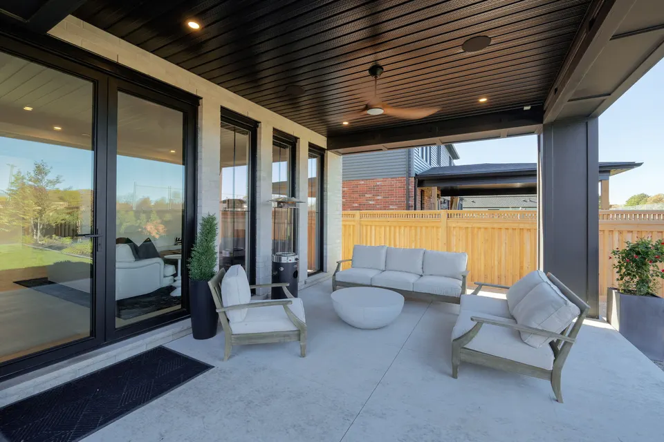 Covered porch seating area under a wood ceiling
